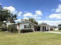 Charming single-story home featuring a well-maintained front lawn and mature trees at 3321 Fuller St # 105, Sarasota, FL 34231