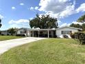 Charming single-story home featuring a covered carport and a well-manicured lawn at 3321 Fuller St # 105, Sarasota, FL 34231