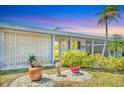 Close-up of the front exterior showcasing decorative concrete block, lush landscaping, and inviting entrance at 3402 Key Ave, Sarasota, FL 34239