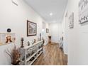Inviting hallway featuring wood-look floors and tasteful decor at 3478 74Th Avenue E Cir, Sarasota, FL 34243