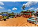A spacious deck with comfortable seating, an outdoor kitchen, and picturesque waterfront views at 3716 Coconut Ter, Bradenton, FL 34210