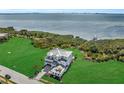 Breathtaking aerial view of waterfront home with expansive yard and private dock at 5210 Inspiration Ter, Bradenton, FL 34210