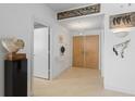 Inviting hallway with neutral tile flooring and modern lighting at 535 Sanctuary Dr # A602, Longboat Key, FL 34228