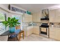 Bright kitchen features stainless steel appliances, granite countertops, and a cozy breakfast nook at 5395 Lake Arrowhead Trl # 24, Sarasota, FL 34231