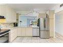 Bright kitchen with stainless steel appliances, light countertops, and view to the outdoor patio at 5395 Lake Arrowhead Trl # 24, Sarasota, FL 34231