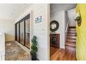 Welcoming entryway with wood floors, sliding glass doors, a decorative mirror, and stairs to the second floor at 548 Beach Rd # 540A, Sarasota, FL 34242