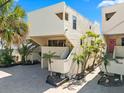 Unique two-story home with neutral siding, small balconies, manicured landscaping, and a brick driveway at 548 Beach Rd # 540A, Sarasota, FL 34242