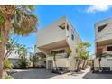 Modern two-story home exterior featuring neutral siding, balconies, landscaping, and a brick driveway at 548 Beach Rd # 540A, Sarasota, FL 34242