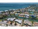 Scenic aerial view of waterfront neighborhood showcasing canals, homes, and blue ocean water at 606 Emerald Ln, Holmes Beach, FL 34217