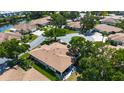 Aerial view of a residential neighborhood with homes, green spaces, and a nearby pond at 6102 Penny Ln, Bradenton, FL 34207