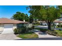 A residential street showcasing well-kept lawns, mature landscaping, and charming single-story homes at 6102 Penny Ln, Bradenton, FL 34207