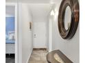 Inviting entryway featuring tile floors, decor, and a glimpse of the main bedroom at 625 Beach Rd # 207, Sarasota, FL 34242