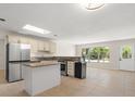 Bright kitchen with island, stainless steel appliances, and skylight at 6732 Washington Pl, Bradenton, FL 34207
