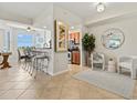 Inviting living room flows to the kitchen, featuring tile floors, neutral walls, and comfortable seating at 7705 Grand Estuary Trl # 202, Bradenton, FL 34212