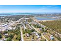 An aerial view of a single-story home with a community view with access to a pond and the ocean at 8308 Pelican Rd, Englewood, FL 34224
