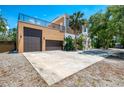Spacious home featuring a two-car garage and a rooftop balcony providing stunning views of the surrounding neighborhood at 95 Vic Edwards Rd, Sarasota, FL 34240