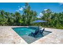 Inviting in-ground pool with a tanning ledge, spa, and comfortable lounge chairs, perfect for relaxing and entertaining at 95 Vic Edwards Rd, Sarasota, FL 34240