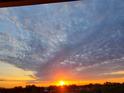 A view of a vibrant sunset with colorful clouds at 1030 Tidewater Shores Loop # 404, Bradenton, FL 34208