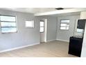 Living room area with many windows, light colored walls and flooring at 1220 12Th W Ave, Palmetto, FL 34221