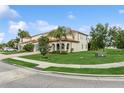 Expansive corner lot with a meticulously maintained lawn, mature trees, and elegant architectural detailing at 13721 Saw Palm Creek Trl, Lakewood Ranch, FL 34211