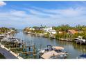 Scenic waterfront view showing boat docks on a canal with blue skies and other homes in the background at 1709 N Tamiami Trl # 318, Sarasota, FL 34234