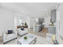 Open-concept living space with neutral furniture, connecting living, dining, and kitchen areas at 172 Eagleston Ln, Sarasota, FL 34240