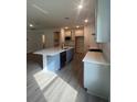 Modern kitchen with stainless steel appliances, large island, and sleek countertops at 19575 Fort King Run, Brooksville, FL 34601
