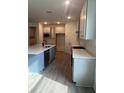 Modern kitchen with stainless steel appliances, large island, and light gray cabinets at 19575 Fort King Run, Brooksville, FL 34601