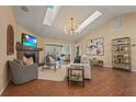 Bright living room with high ceilings, skylights, a fireplace, and an open layout into the connecting rooms at 2072 Misty Sunrise Trl, Sarasota, FL 34240