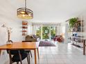 Bright living room featuring modern decor, tile floors, and sliding doors to a balcony at 2155 Wood St # B18, Sarasota, FL 34237