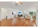 Spacious living room with hardwood floors and natural light, flowing into adjacent rooms for easy living at 3018 Oriole Dr, Sarasota, FL 34243