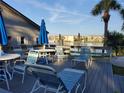 View of a pool deck featuring outdoor furniture, lounge chairs, and a peaceful waterfront view at 3368 Lake Bayshore Dr # 217 Building P, Bradenton, FL 34205