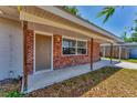 Inviting entrance featuring a brick facade, covered porch, and a well-maintained walkway at 3545 Lalani Blvd, Sarasota, FL 34232