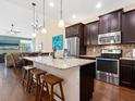 A kitchen with a granite countertop island, modern stainless appliances, and dark cabinets at 3623 Pitch Ln, Sarasota, FL 34232