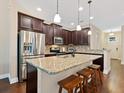 Kitchen featuring granite counters, a large island with seating, and stainless steel appliances at 3623 Pitch Ln, Sarasota, FL 34232