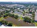Aerial view showcasing the community, including a pond and the city skyline in the background at 3810 N Oak Dr # N61, Tampa, FL 33611