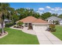 Well-maintained home with a two-car garage, manicured lawn, and an inviting front entrance at 4211 73Rd E Ter, Sarasota, FL 34243
