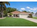 Charming single-story home with a well-manicured lawn, two-car garage, and inviting front entrance at 4211 73Rd E Ter, Sarasota, FL 34243