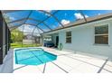 Screened-in pool area with sunny white deck, hose, and outdoor seating at 4325 Renwick Dr, Parrish, FL 34219