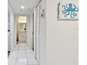Bright hallway leading to bathroom, with a linen closet and an octopus wall decoration at 4460 Fairways Blvd #604 Blvd # 604, Bradenton, FL 34209