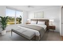 Light filled main bedroom featuring a golf course view, neutral colors and bench at 4570 Pinebrook Cir # 406, Bradenton, FL 34209