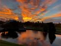 Picturesque sunset view overlooking the lake and lush green landscape at 4570 Pinebrook Cir # 406, Bradenton, FL 34209