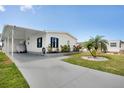 Charming single-story home with a covered carport, manicured lawn, and well-maintained landscaping at 520 Ideal Pl, North Port, FL 34287