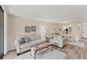 Cozy living room featuring comfortable seating and view into dining area at 5264 Lake Village Dr # 48, Sarasota, FL 34235