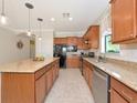 Well-lit kitchen boasts stainless appliances, granite countertops, and ample cabinet space at 5952 Snowy Egret Dr, Sarasota, FL 34238