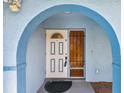 Inviting front door beneath an archway with decorative glass panels, adding character to the home's entrance at 6004 10Th Ave W, Bradenton, FL 34209