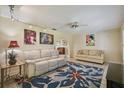 Bright living room with comfortable seating, ceiling fan, and stylish rug for a cozy gathering space at 6004 10Th Ave W, Bradenton, FL 34209