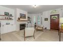 Bright living room featuring a fireplace, built-in shelves, and modern decor at 6015 S Elkins Ave, Tampa, FL 33611