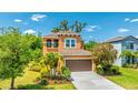 Charming two-story home with lush landscaping and an attached two car garage at 6111 Horse Mill Pl, Palmetto, FL 34221