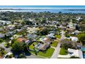 A Stunning aerial shot reveals a home with a pool surrounded by lush landscaping in a peaceful, established neighborhood at 7301 12Th W Ave, Bradenton, FL 34209